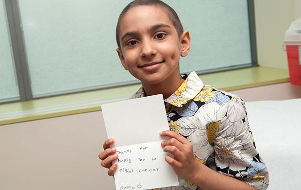 Pediatric international patient with thank you card for staff